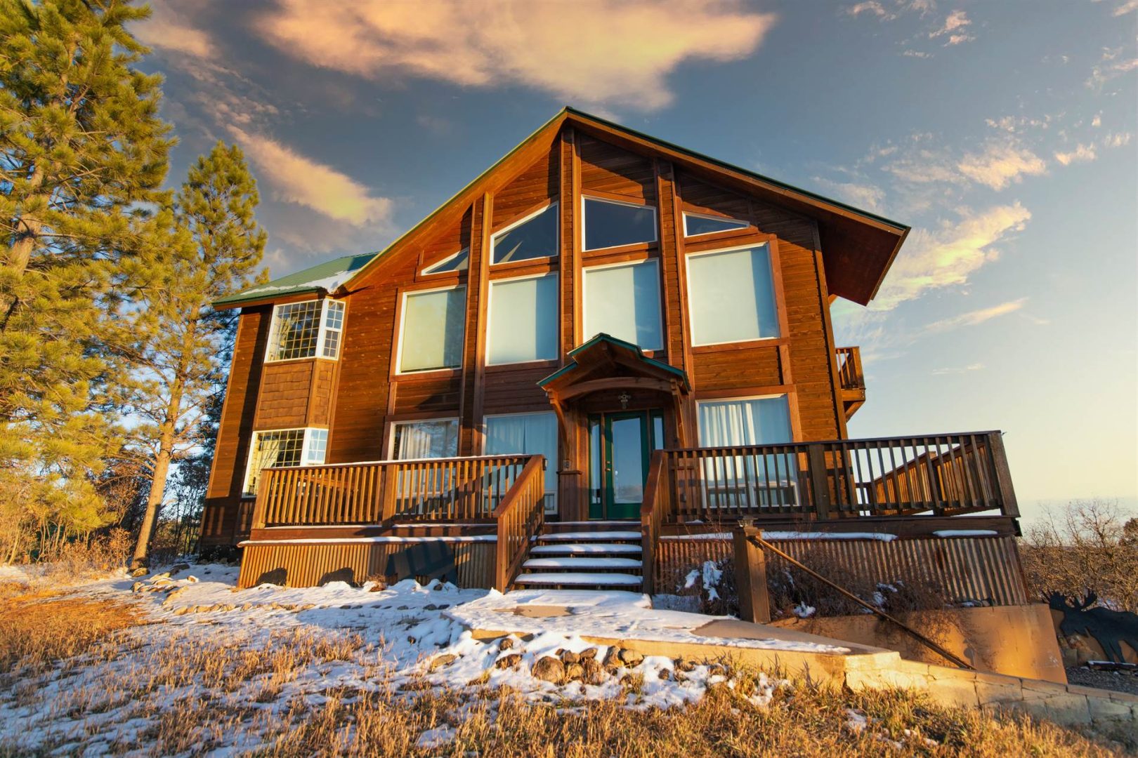 A wooden house with snow on the ground.