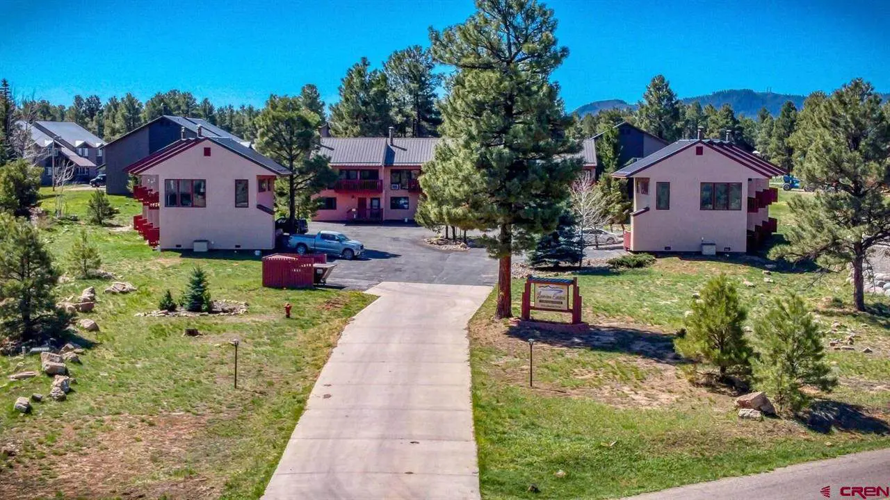 An aerial view of an apartment complex in the mountains.