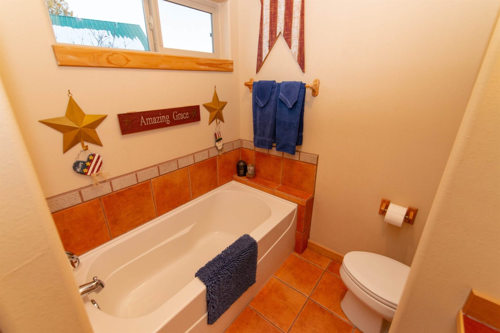 A bathroom with a tub and toilet.