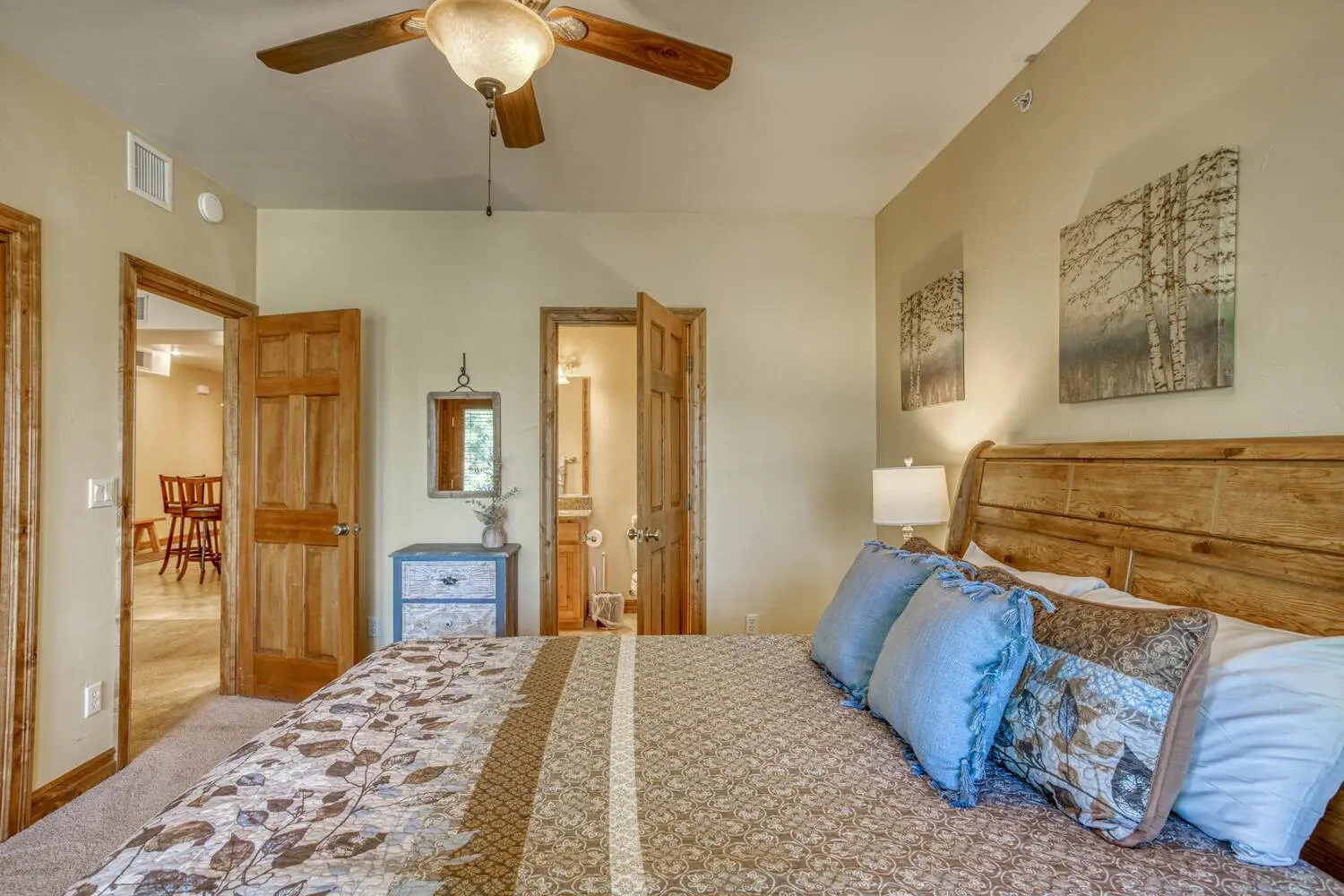 A bedroom with a bed and a ceiling fan.