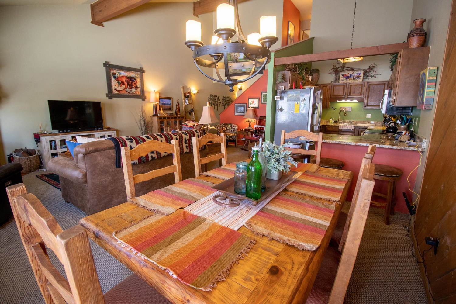 A living room with a wooden table and chairs.