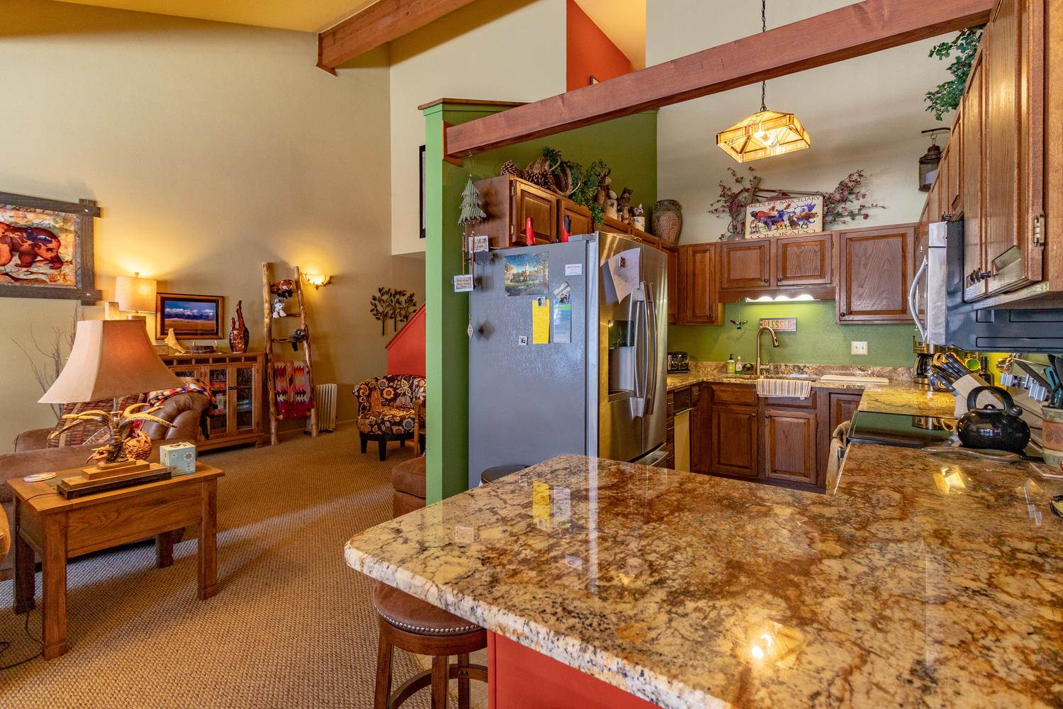 A kitchen with granite counter tops and a fireplace.