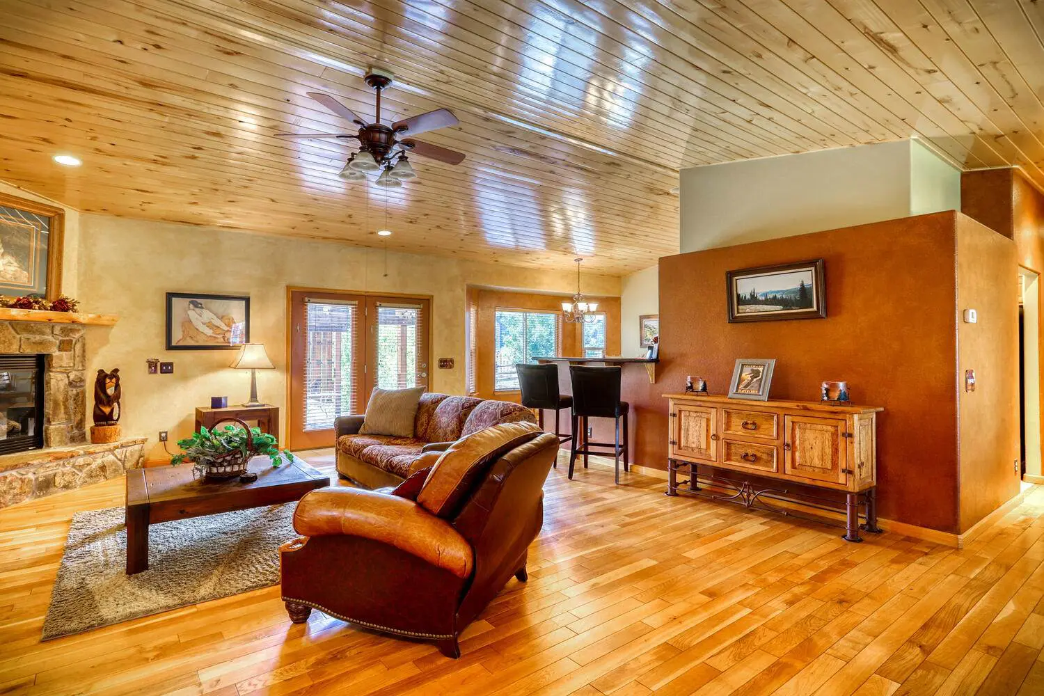 A living room with hardwood floors and a fireplace.