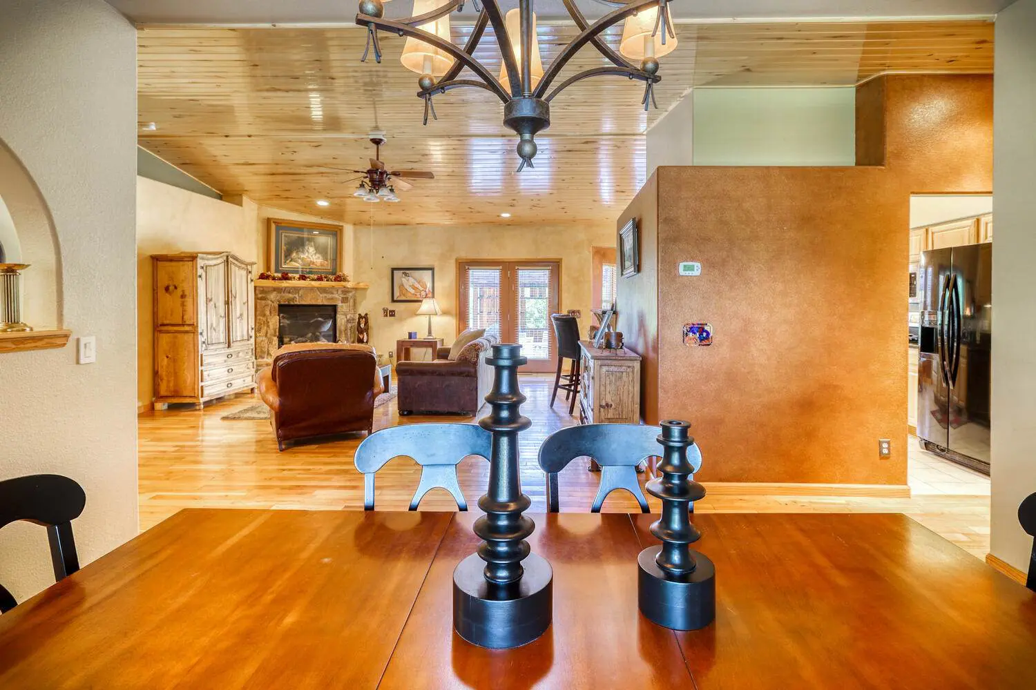 A dining room with a wooden table and chairs.