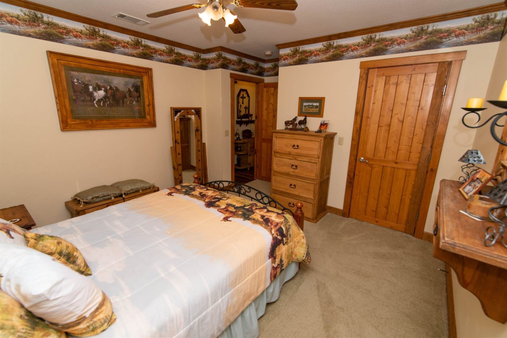 Room with a beautiful bed along with a mirror