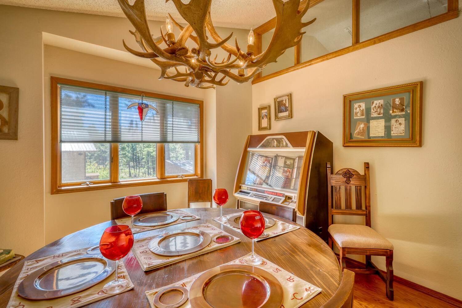 A dining room with antlers hanging from the ceiling.