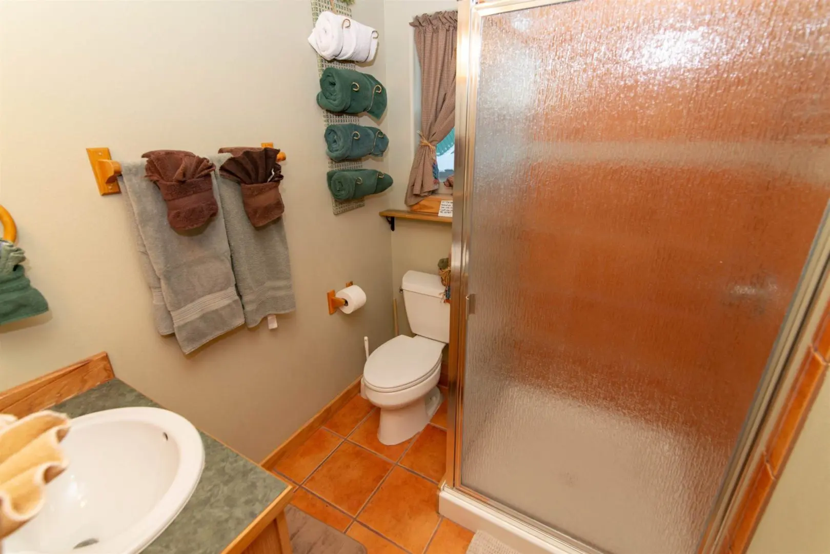 A bathroom with a glass shower door.