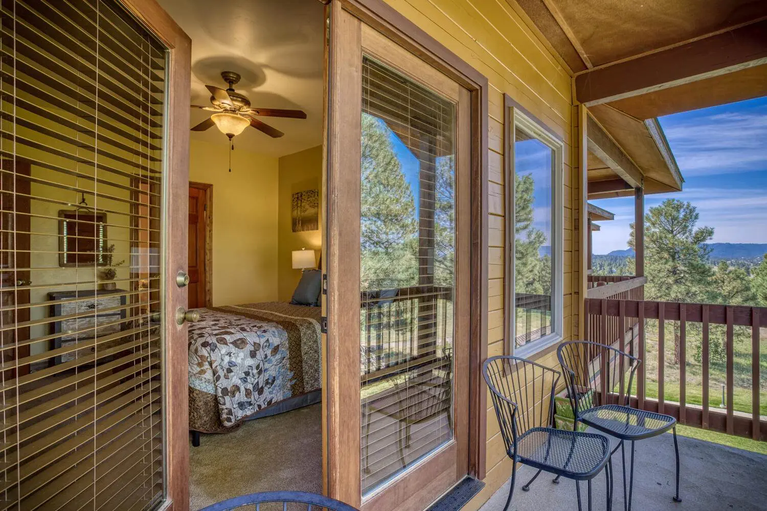 A bedroom with sliding glass doors and a view of the mountains.