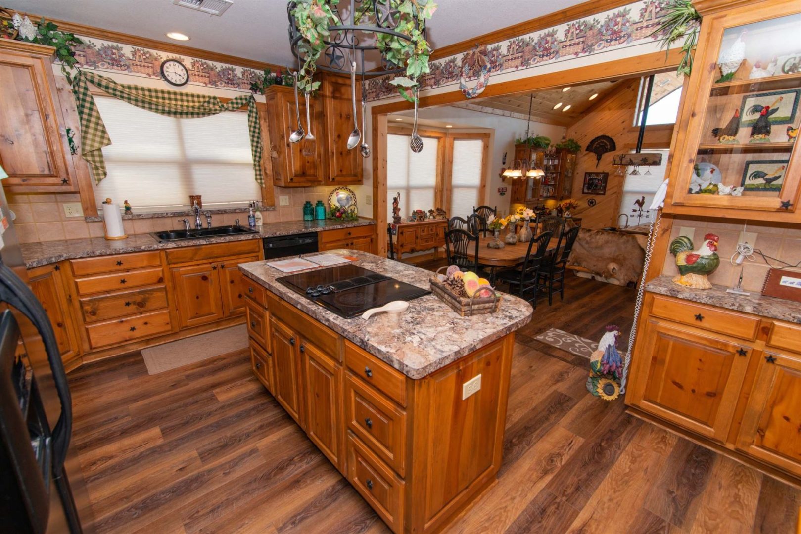 Room with a kitchen along with a table and basin