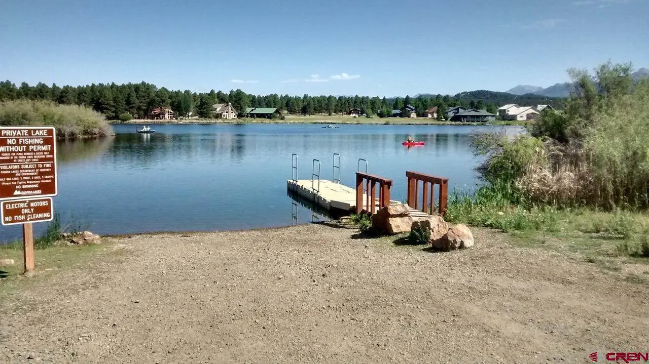 A lake with a dock next to it.