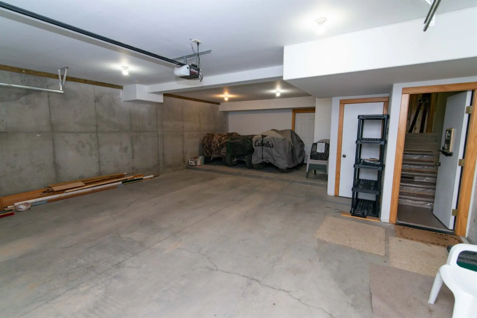 A garage with a concrete floor and a ladder.