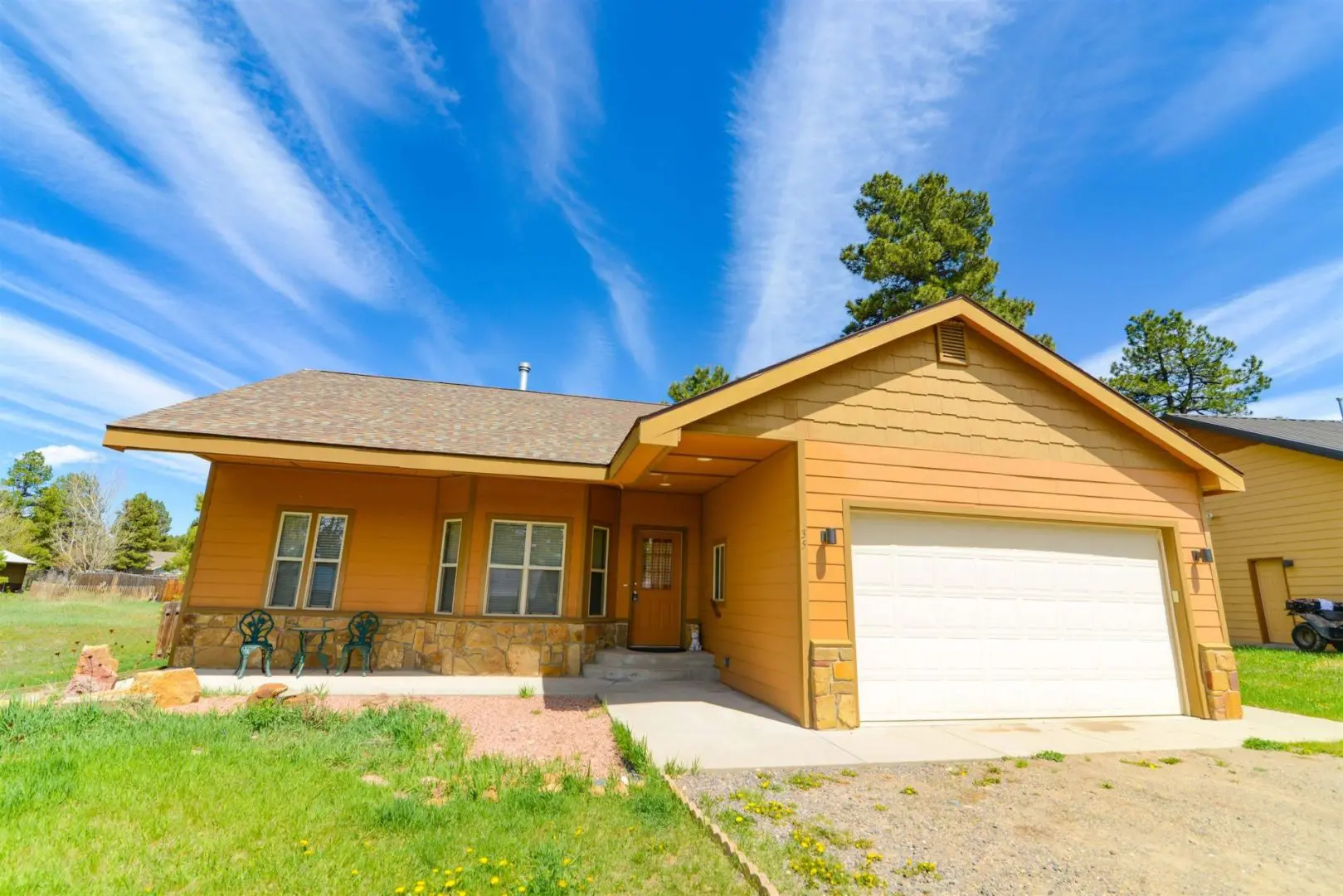 A home with a garage in front of it.