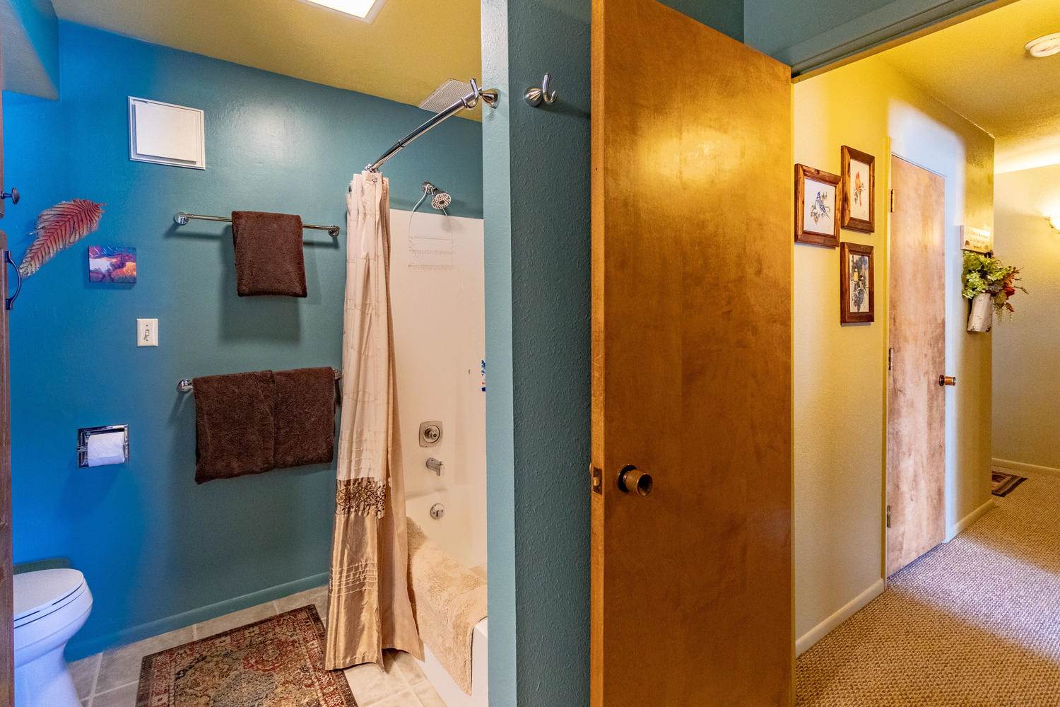 A bathroom with blue walls and a toilet.