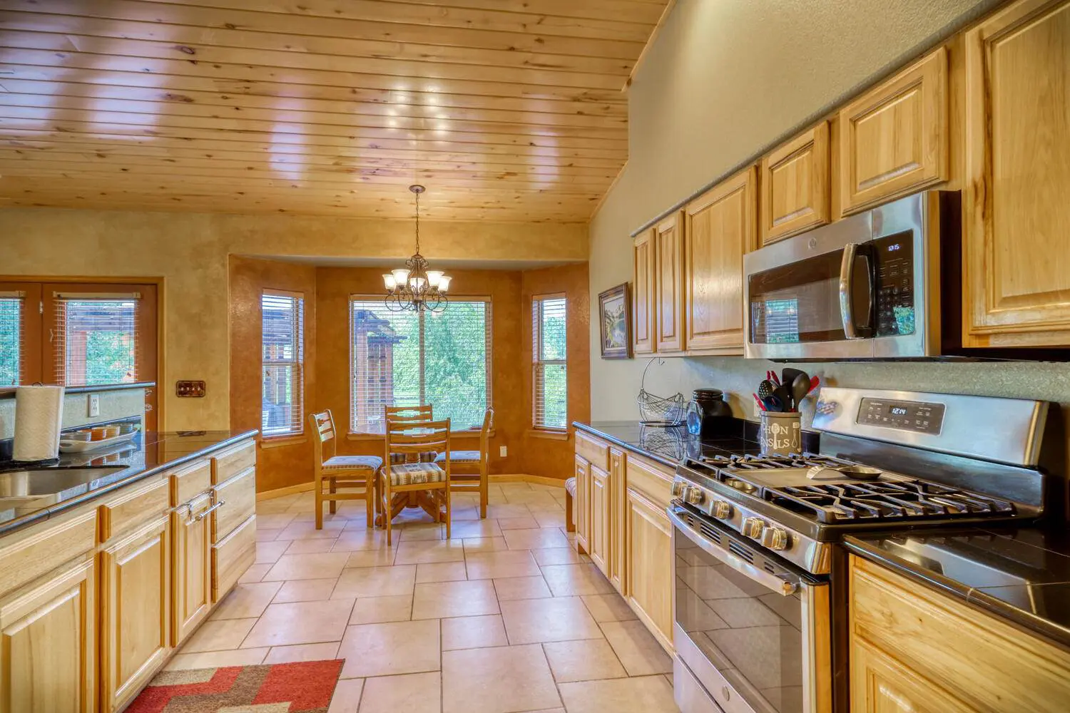 A kitchen with wood cabinets and stainless steel appliances.