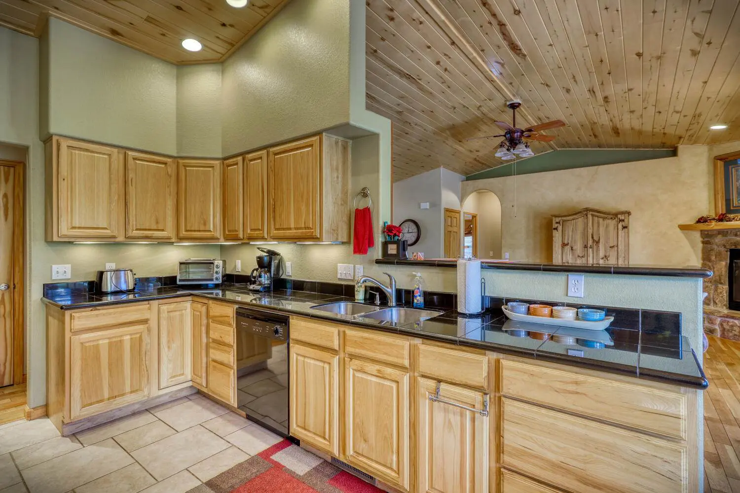 A kitchen with wood cabinets and a ceiling fan.