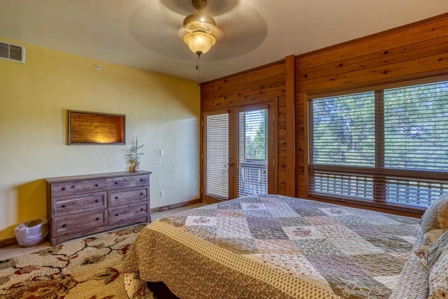 A bedroom with a bed and a dresser.