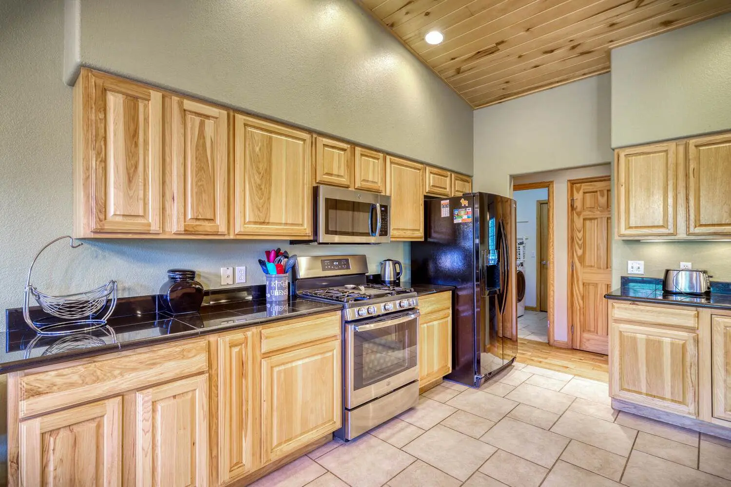 A kitchen with wood cabinets and stainless steel appliances.