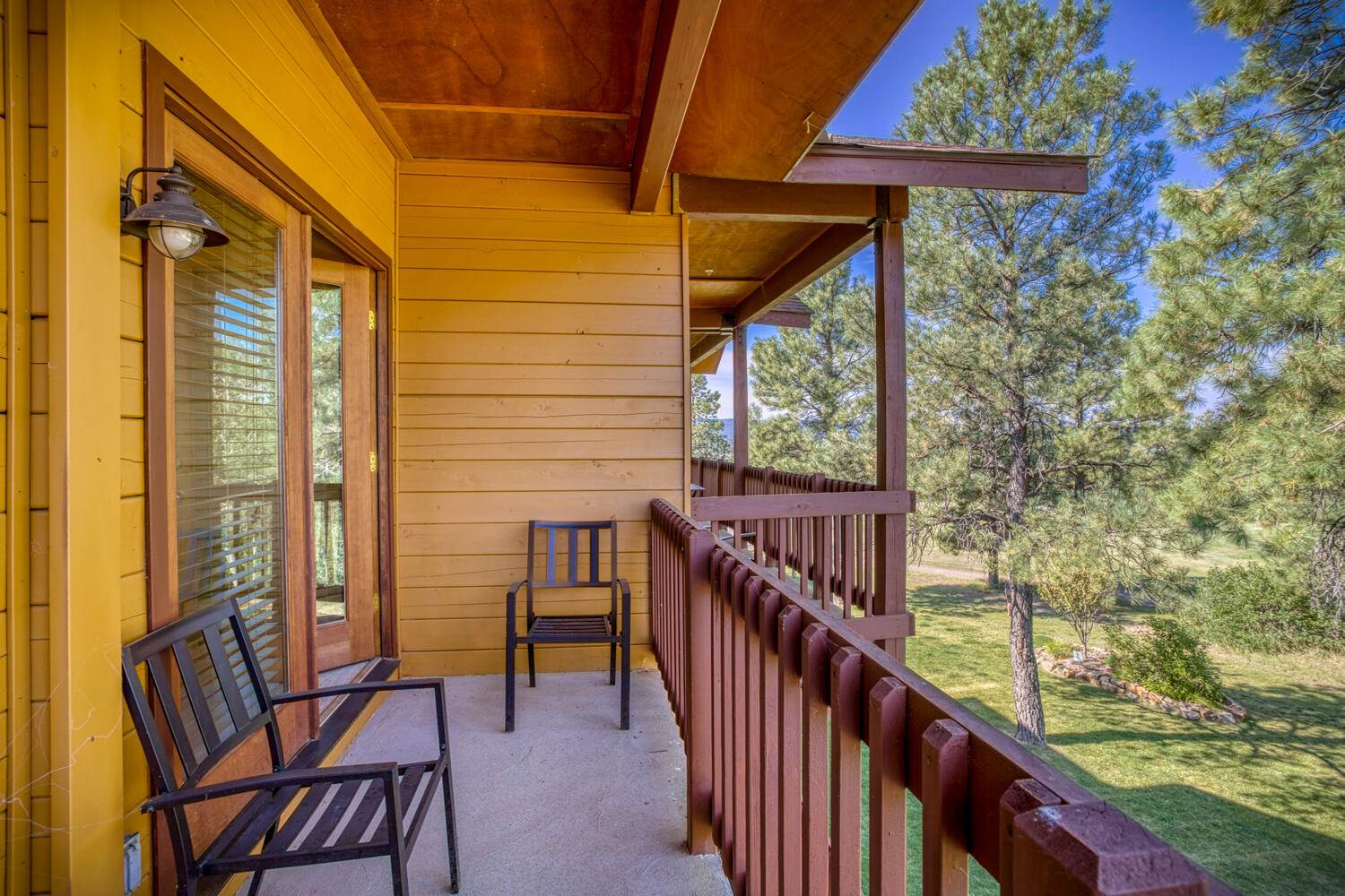 A balcony with chairs and a view of the mountains.