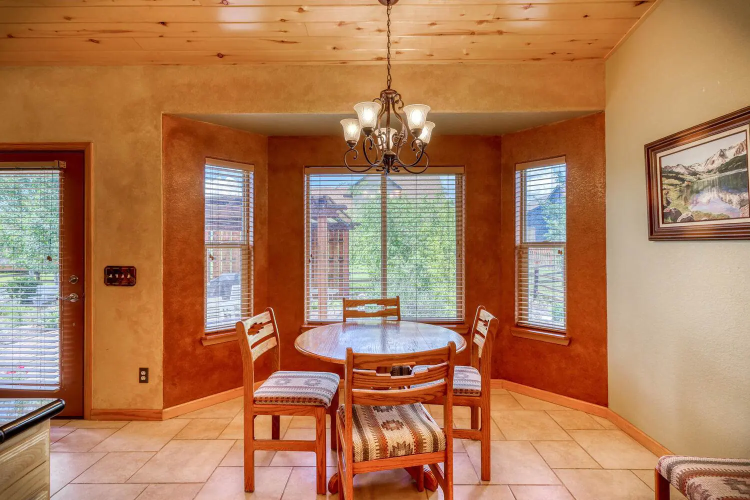 A dining room with a table and chairs.