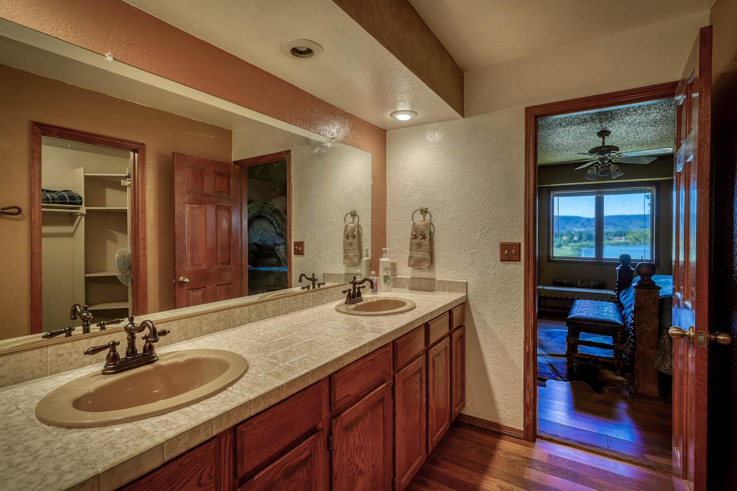 A bathroom with two sinks and a mirror.