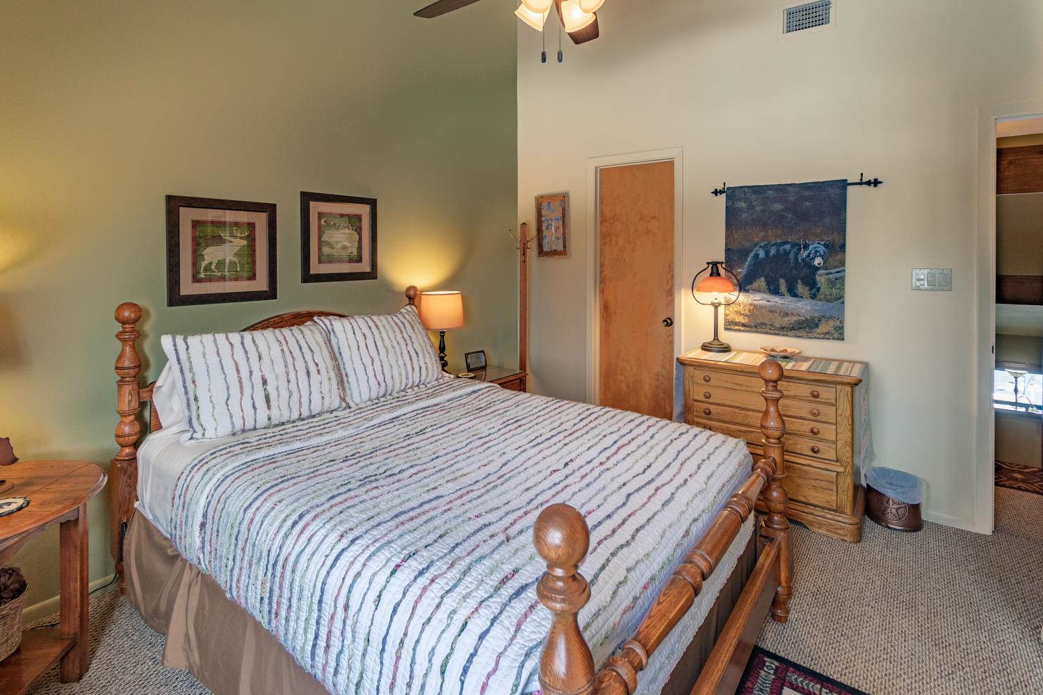 A bedroom with a bed and a ceiling fan.