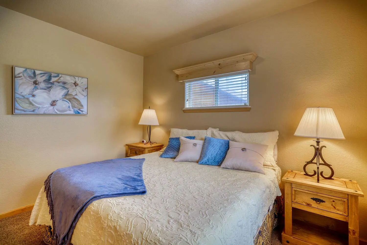 A bedroom with a bed and two nightstands.