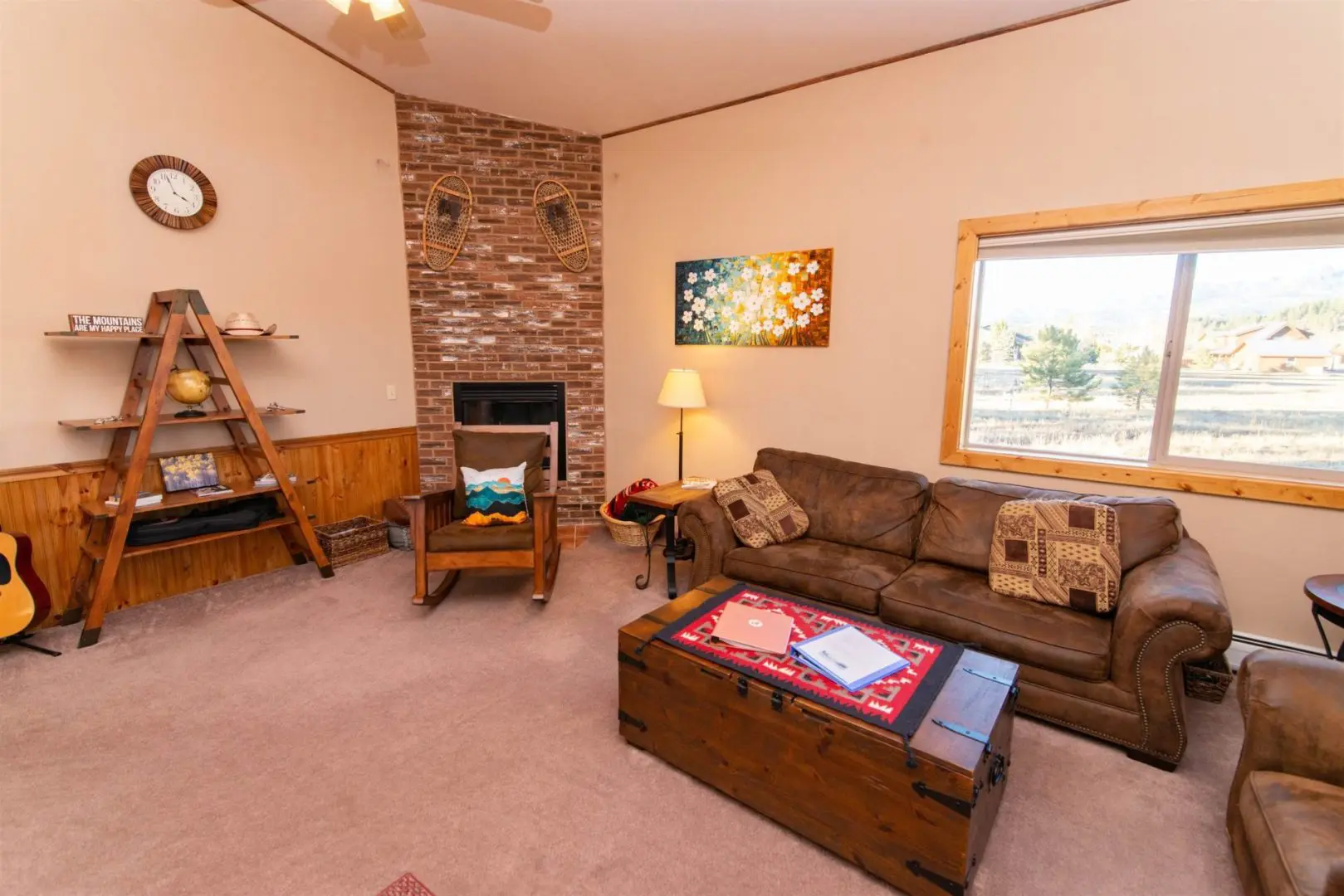 A living room with couches and a fireplace.