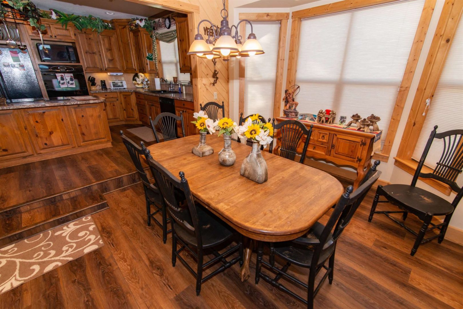 Kitchen area of a house along with a table set