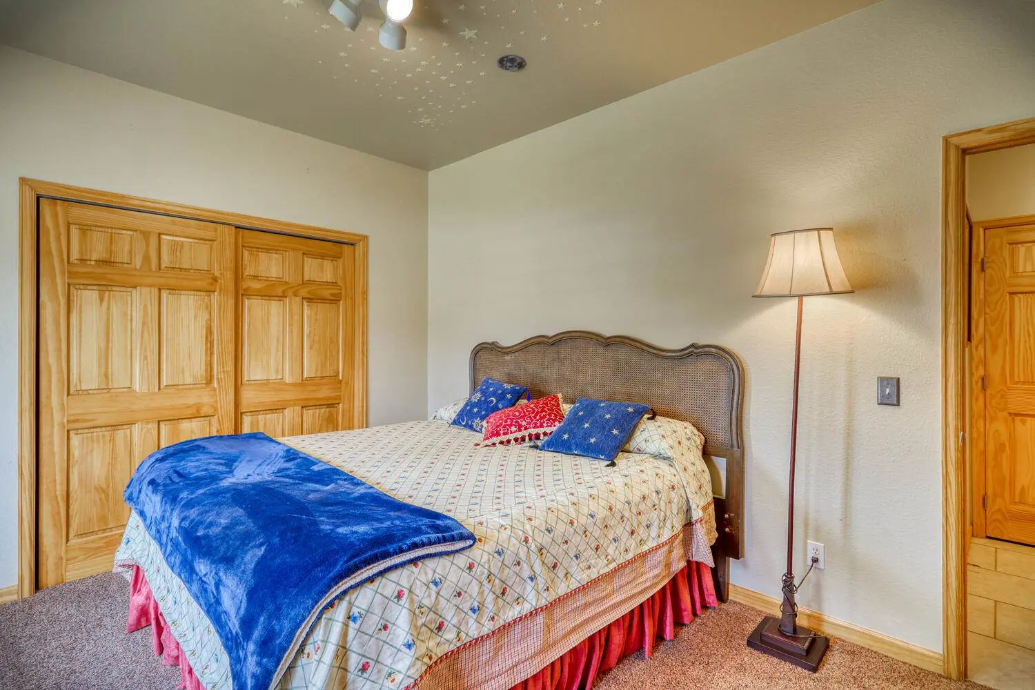 A bedroom with a bed and a dresser.