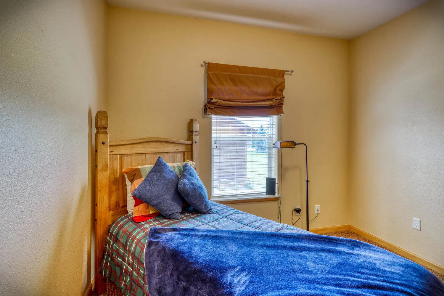 Bed covered with blue color bedsheet