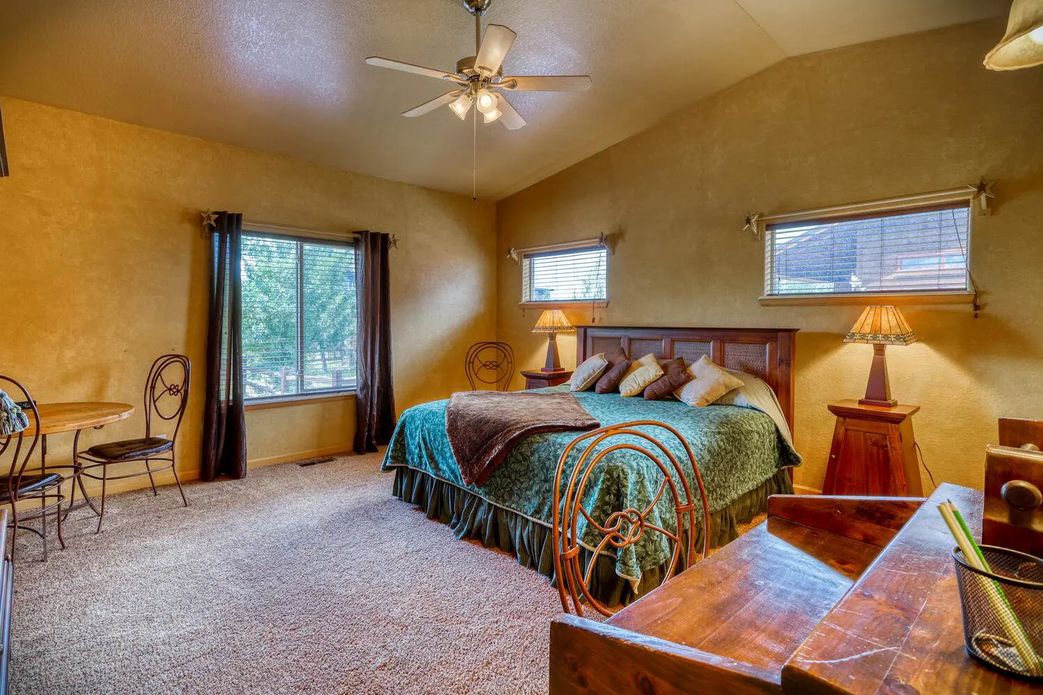 A bedroom with a bed and a bedside table.