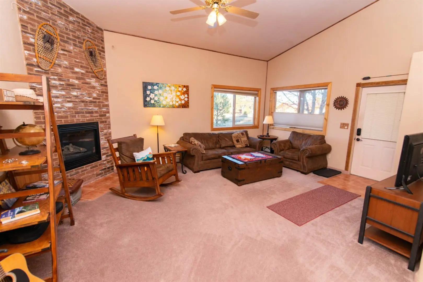 A living room with a fireplace and couches.