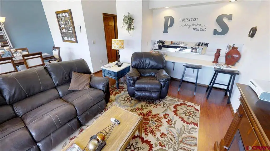 A living room with leather furniture and a coffee table.