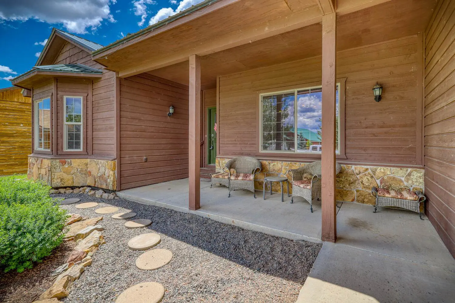 The front porch of a home with a rocking chair.