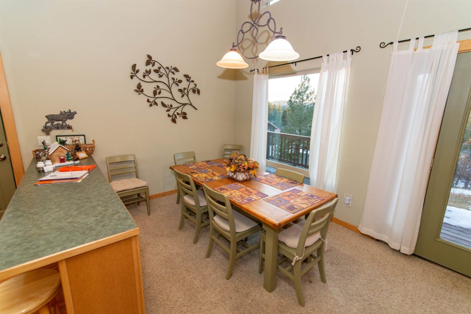 A dining room with a table and chairs.