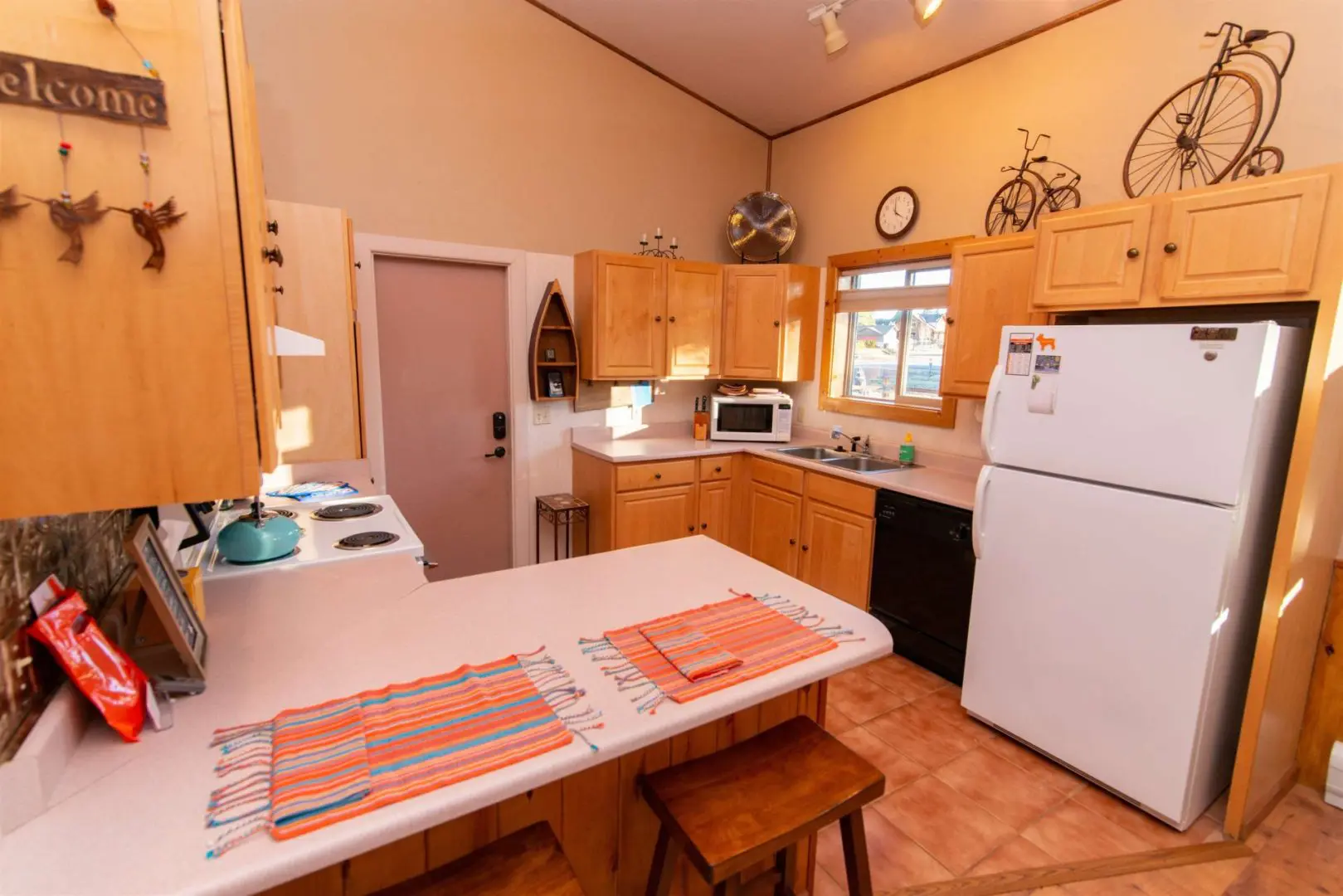 A kitchen in a cabin with a stove and refrigerator.