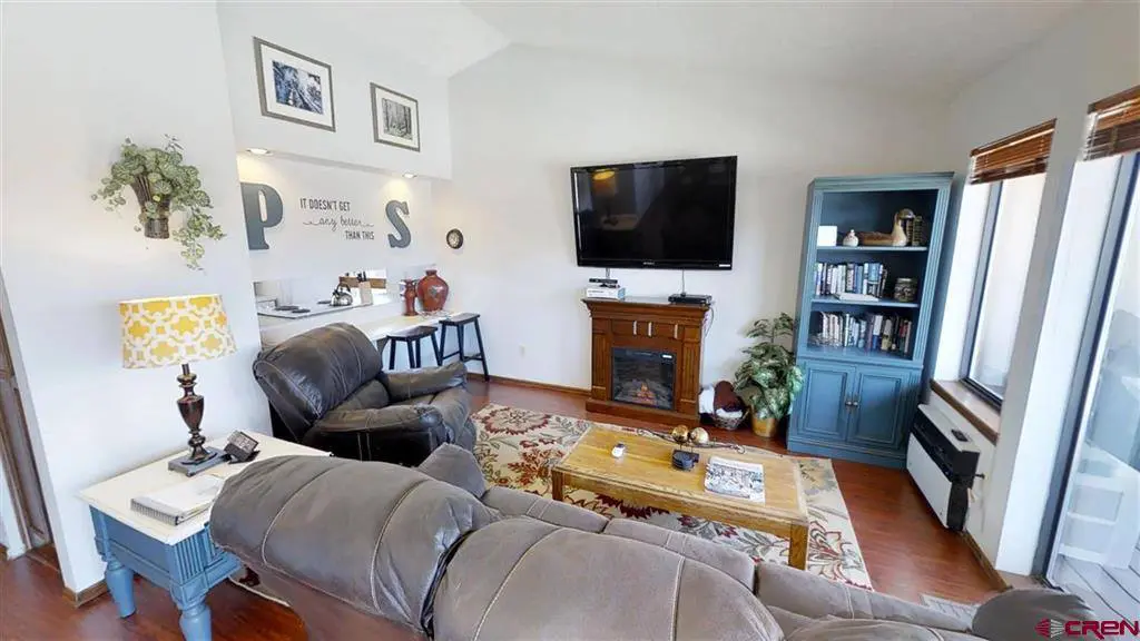 A living room with couches and a tv.