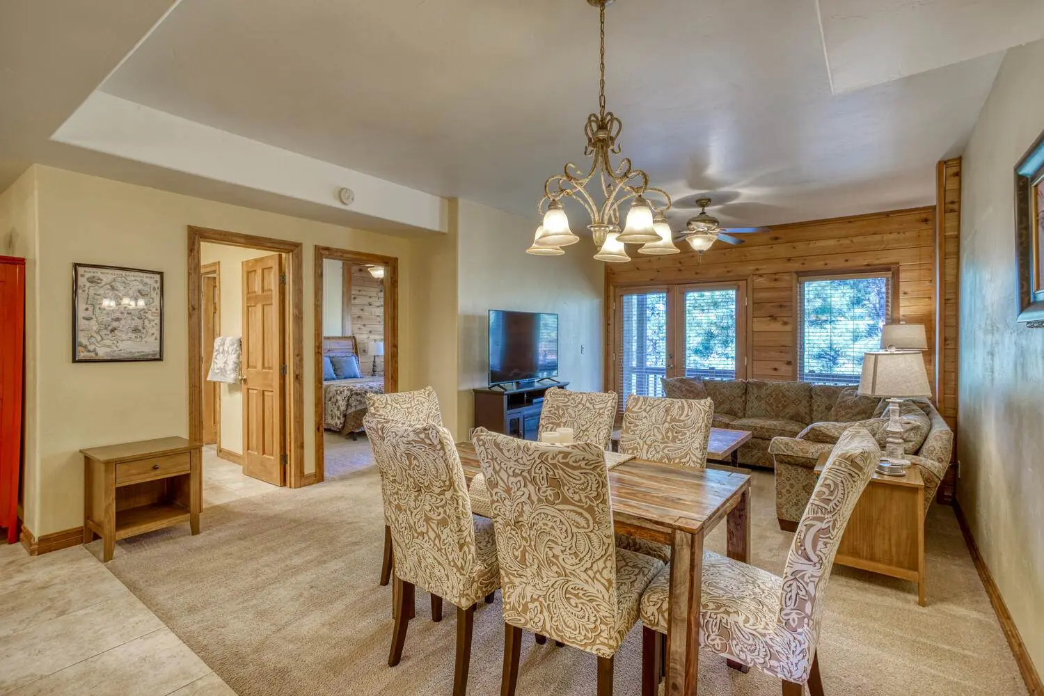 A living room with a dining table and chairs.