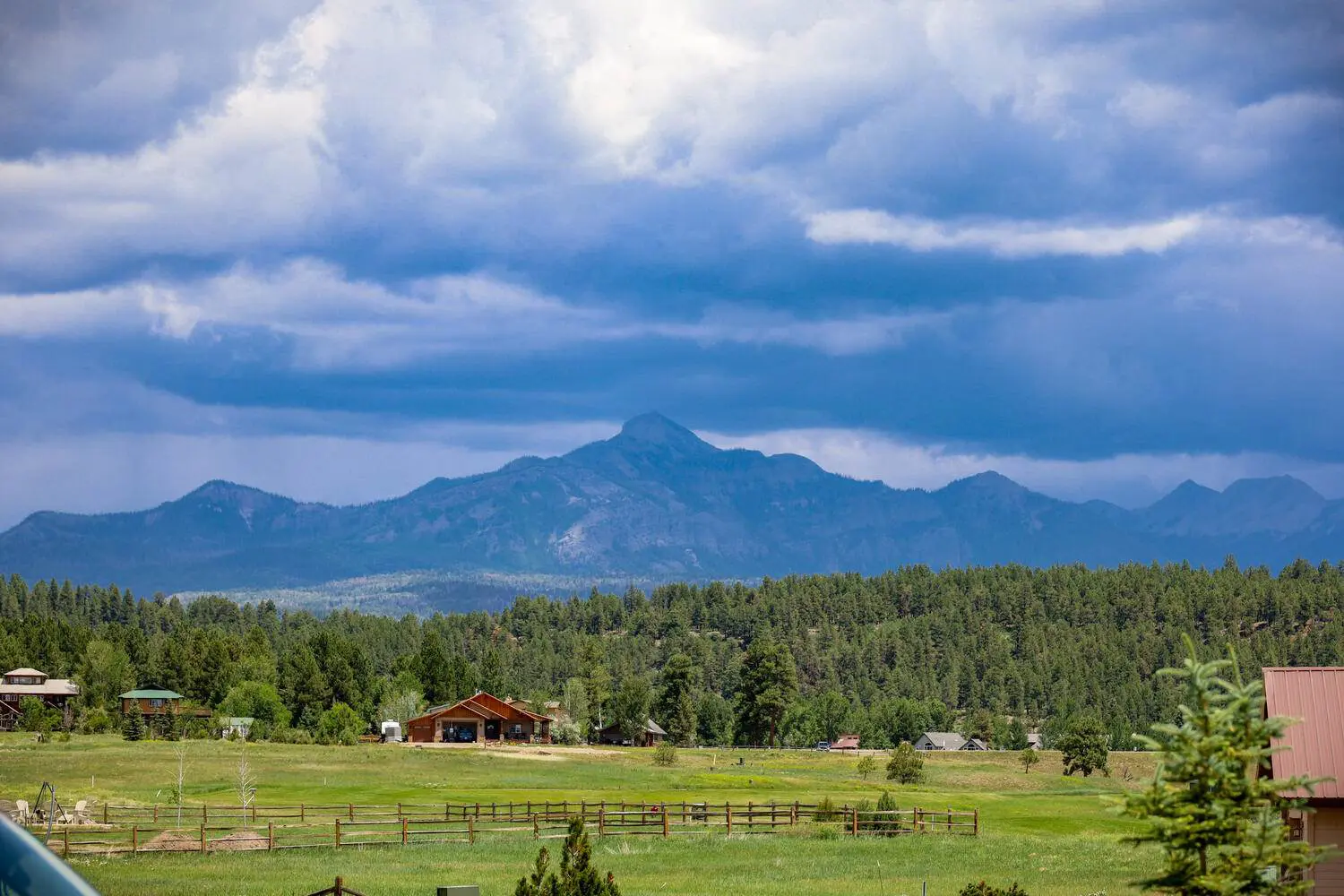 A view of a field with mountains in the background.