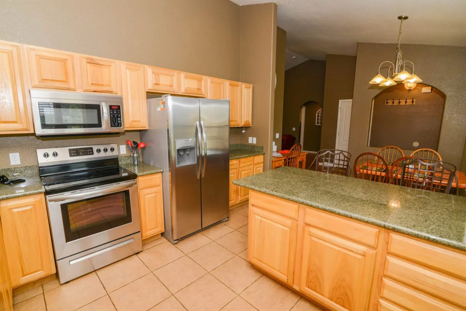 A kitchen with stainless steel appliances and granite counter tops.