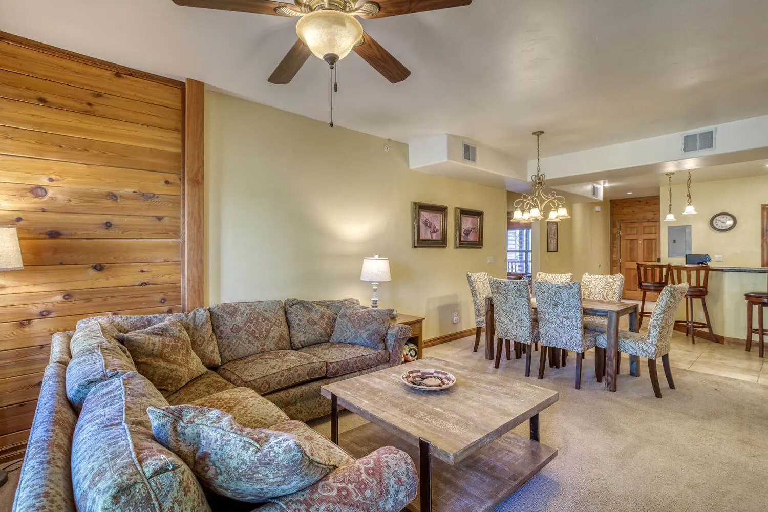 A living room and dining area with a ceiling fan.