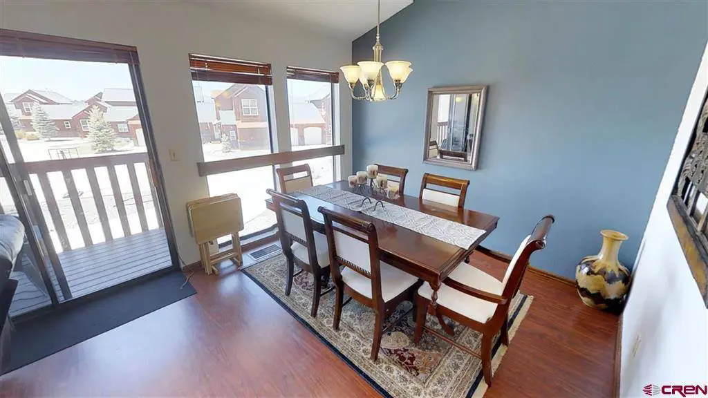 A dining room with a table and chairs.