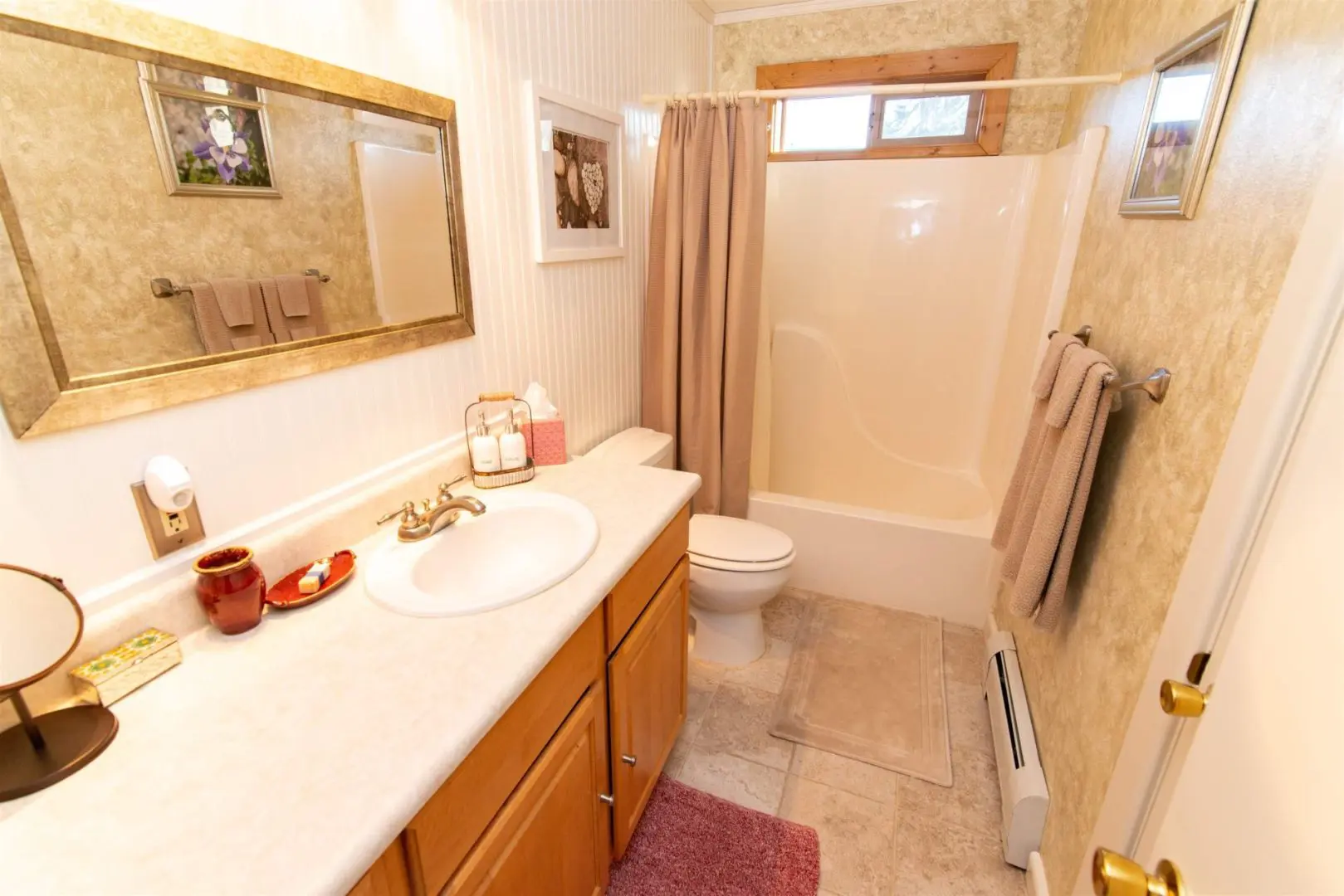 A bathroom with a sink, toilet and shower.