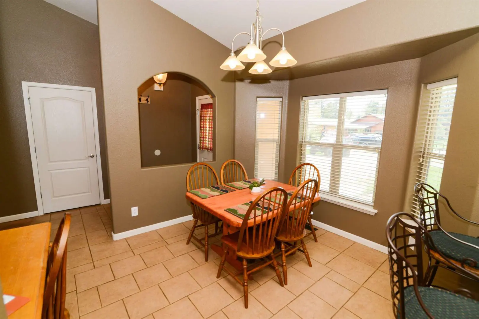 A dining room with a table and chairs.