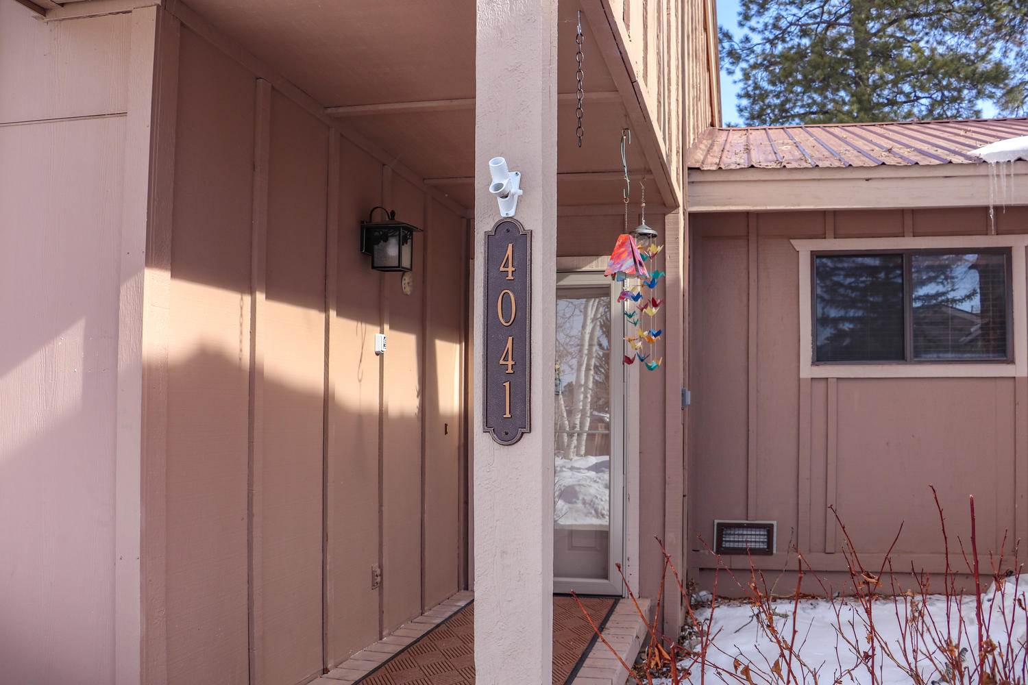 The front door of a home has a sign on it.