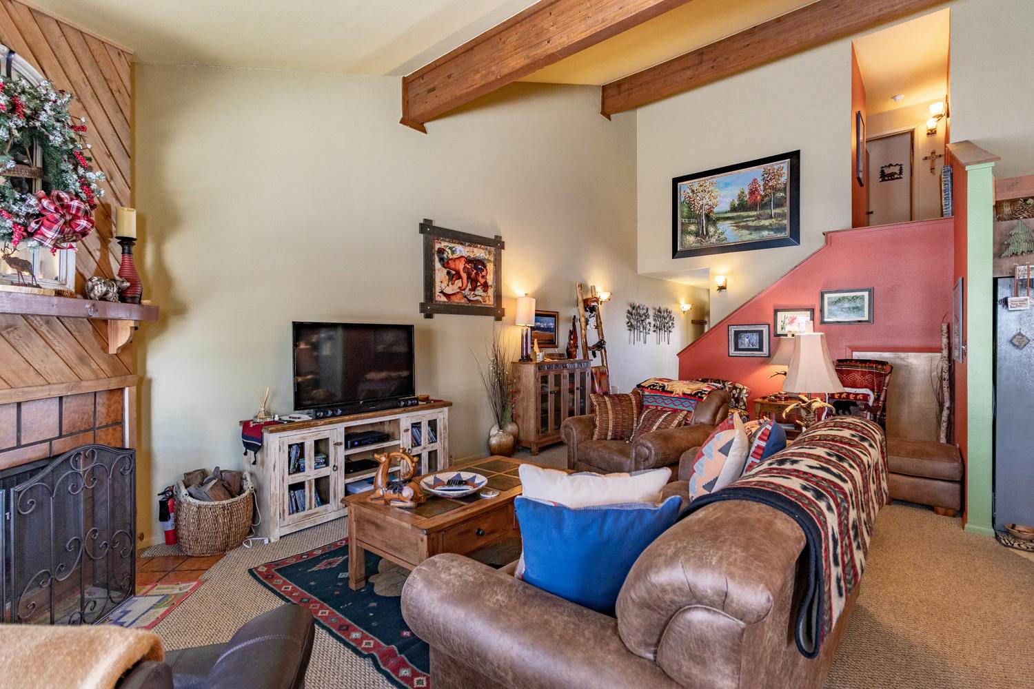 A living room with couches and a fireplace.