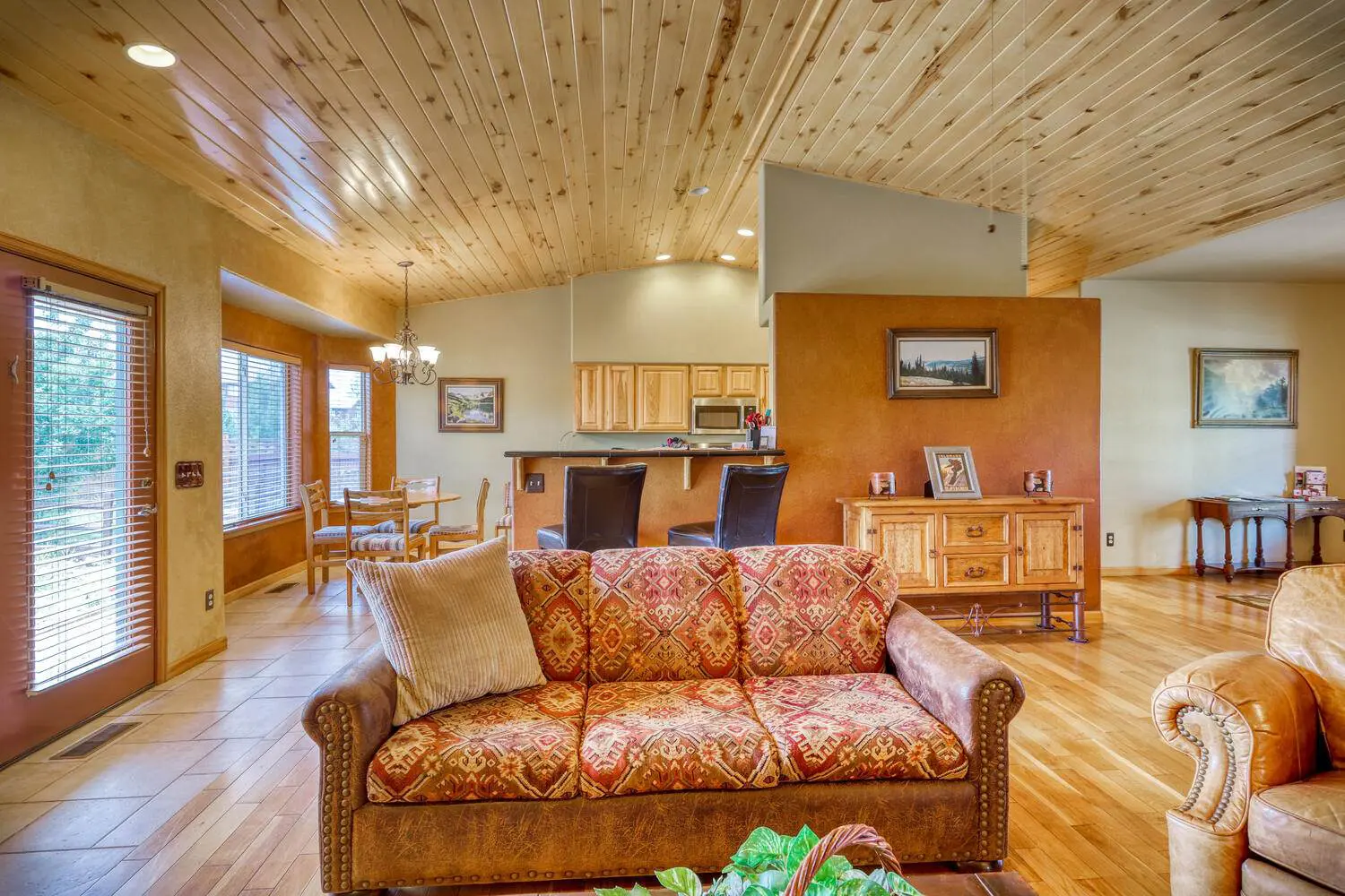 A living room with a wooden ceiling.