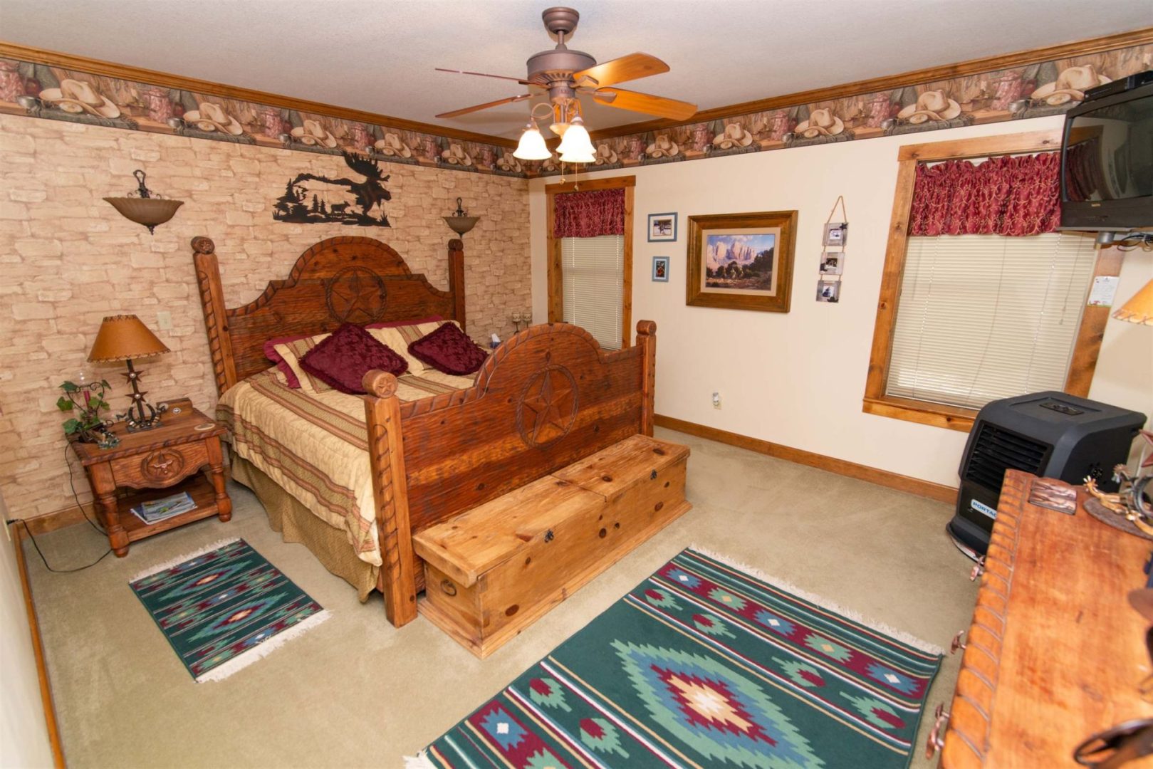 A Western Retreat Room With A Bed And A Fan