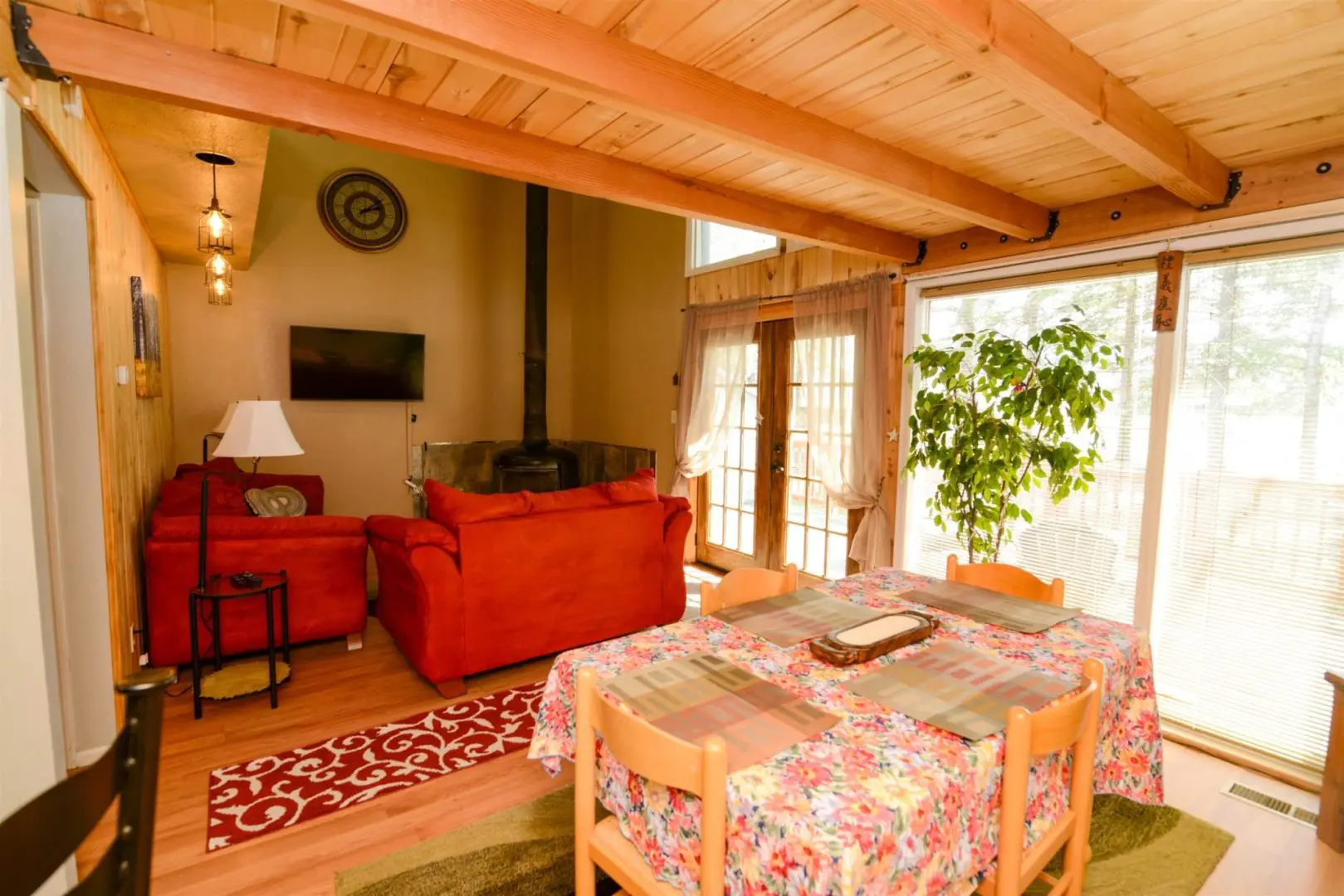 A living room with a dining table and chairs.