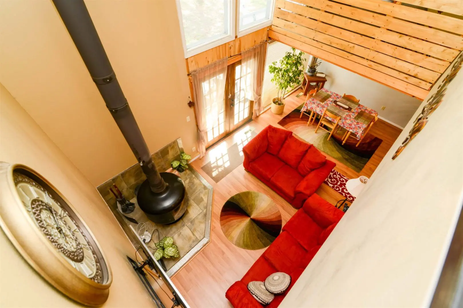 A view of a living room with red couches and a fireplace.